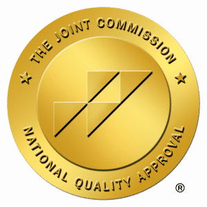 A gold medal inscribed with The Joint Commission National Quality Approval.