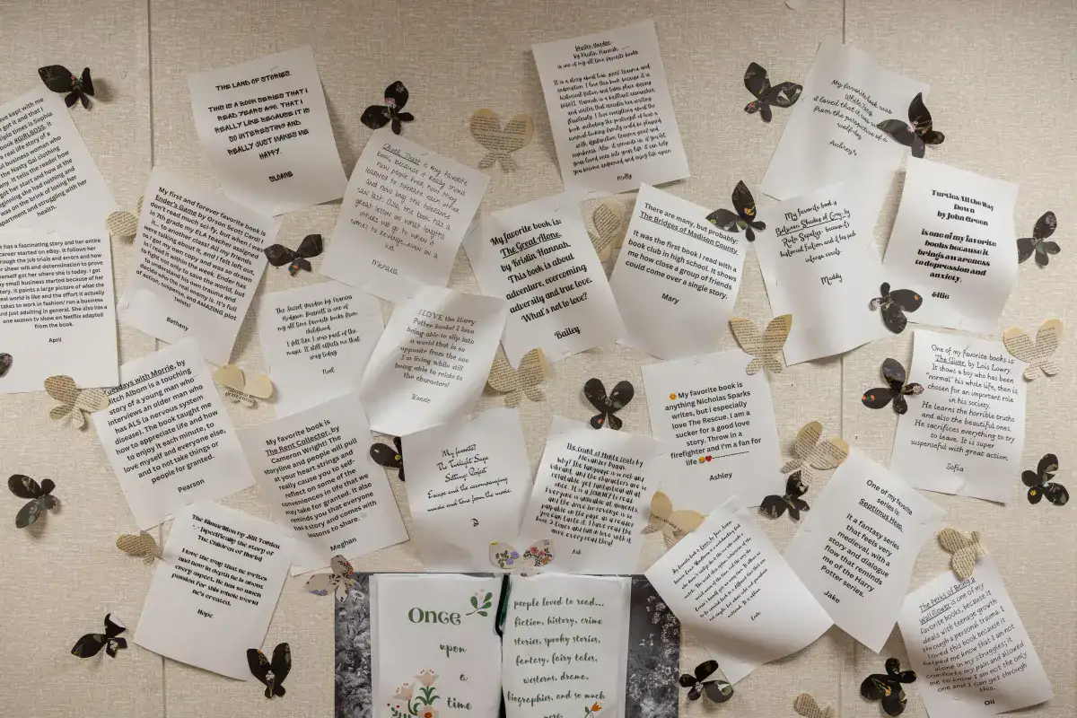 An artful display of printed papers at a therapeutic school explaining why certain books are students' favorites.