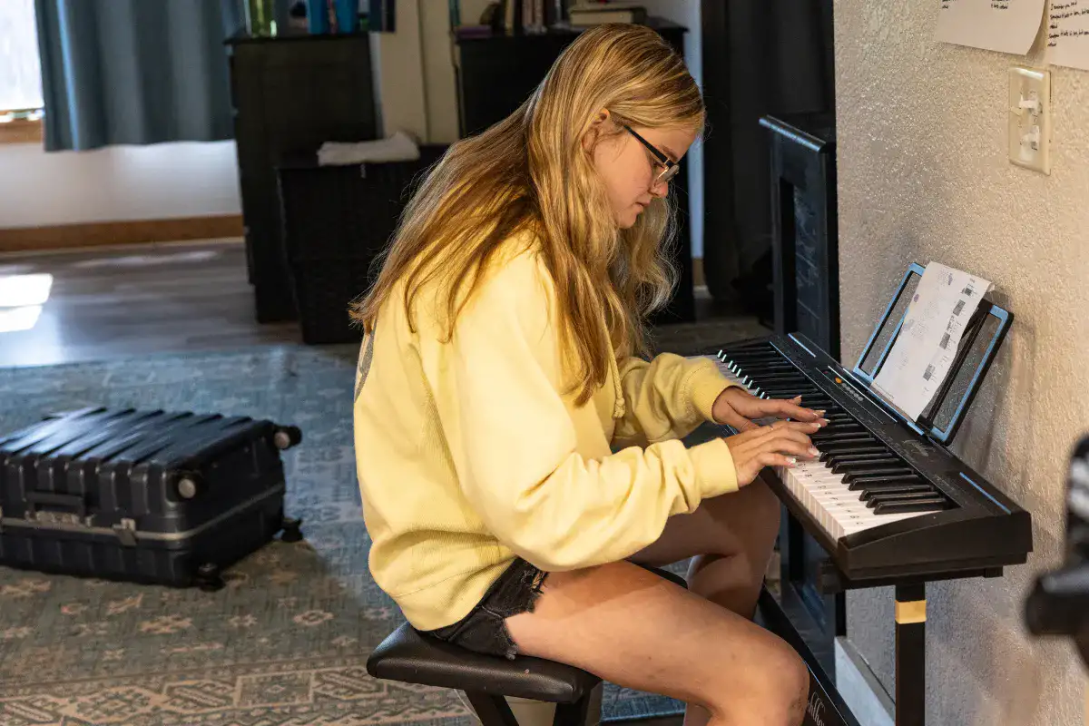 A student practicing piano outside her bedroom at Lake House Academy therapeutic school.